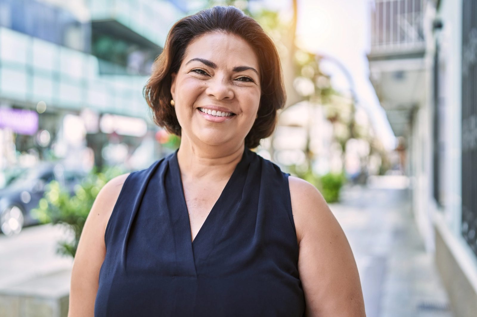 A smiling woman with short brown hair outdoors